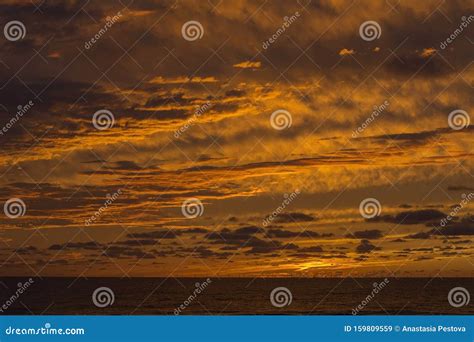 Beautiful Yellow Sundown Over The Sea With Many Clouds Stock Image