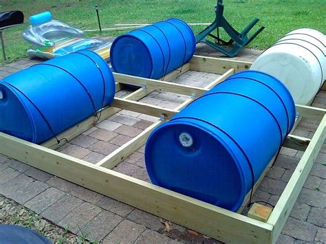 Several Large Blue Barrels Sitting On Top Of A Wooden Platform