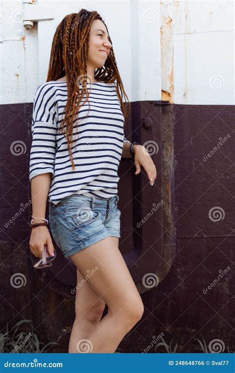 A Girl With A Dreadlocked Hairstyle Poses In The Summer Outdoors