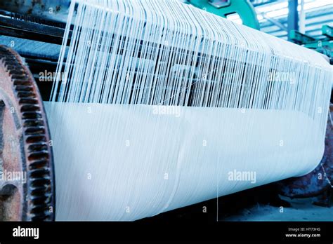 A Row Of Textile Looms Weaving Cotton Yarn In A Textile Mill Stock
