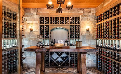 The wine cellar must be constructed and designed just like a natural cave when considering building it. Beautiful rustic wine cellar design. Stone walls and wood racks. Glass french doors. Chandelier ...