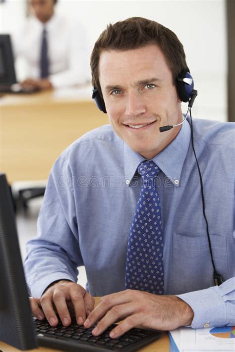 Friendly Service Agent Talking To Customer in Call Centre Stock Image ...