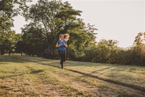 Young Woman Running Jogging In The Park Exercising Outdoor Stock