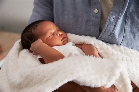 Newborn Baby Being Held In Arms Wyoming Department Of Health