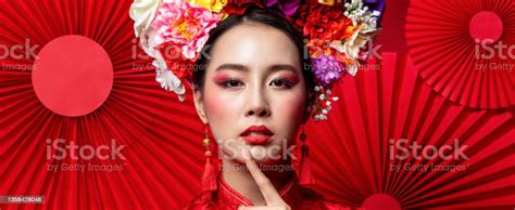 Gorgeous Asian Woman In Traditional With Colorful Make Up And Flower