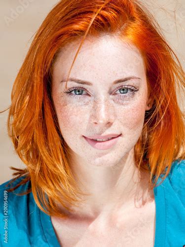 Outdoor Portrait Of A Beautiful Redhead Freckled Blue Eyed Woman Stock