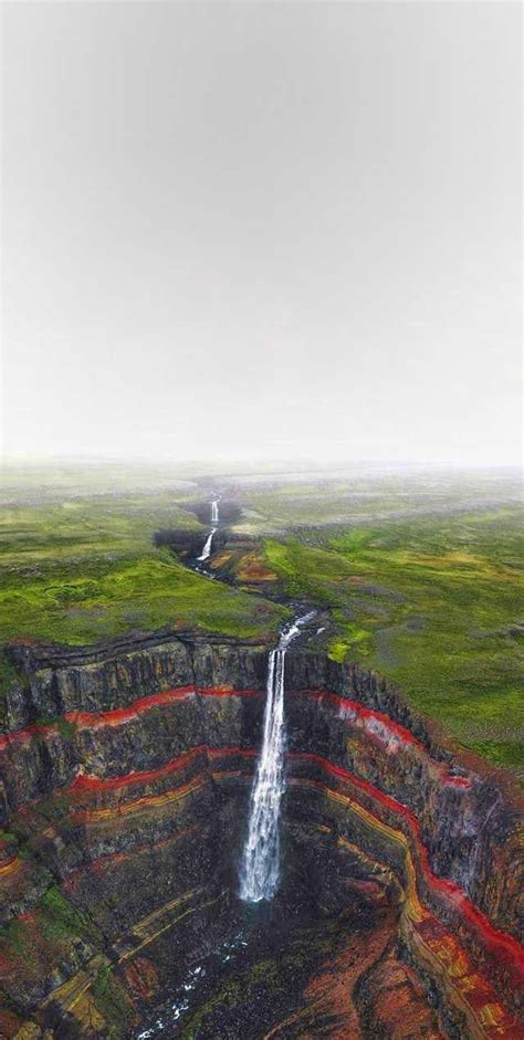 An Aerial View Of A Waterfall In The Middle Of Nowhere