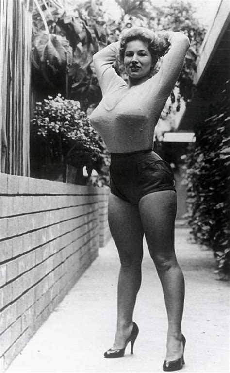 An Old Black And White Photo Of A Woman In High Heels Posing For The Camera