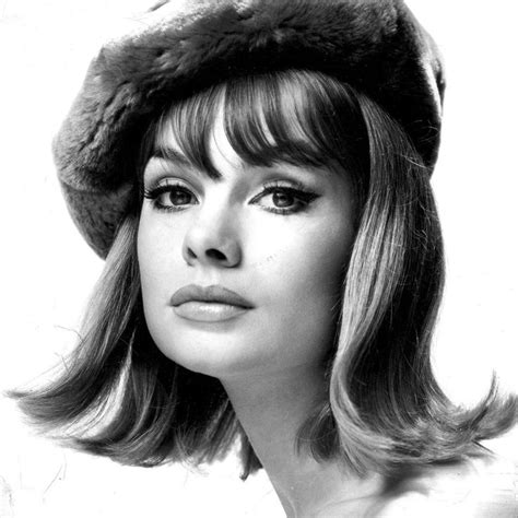 A Black And White Photo Of A Woman With Long Hair Wearing A Fur Hat On