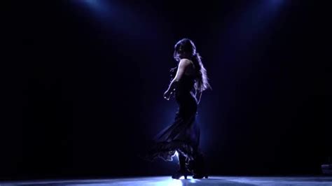 Girl Is Dancing In A Dark Room With Graceful Hand Movements Llight