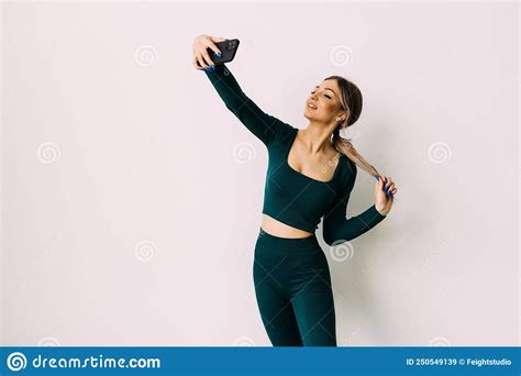 Young Smiling Sporty Athletic Fitness Trainer Instructor Woman Doing