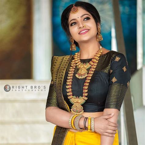In A Bridal Look In Yellow Color Pattu Kanjeevaram Saree With Big Border High Neck Elbow
