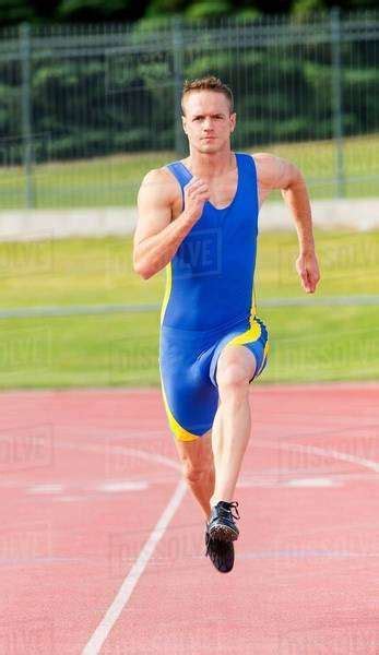 Male Athlete Running On Track Stock Photo Dissolve