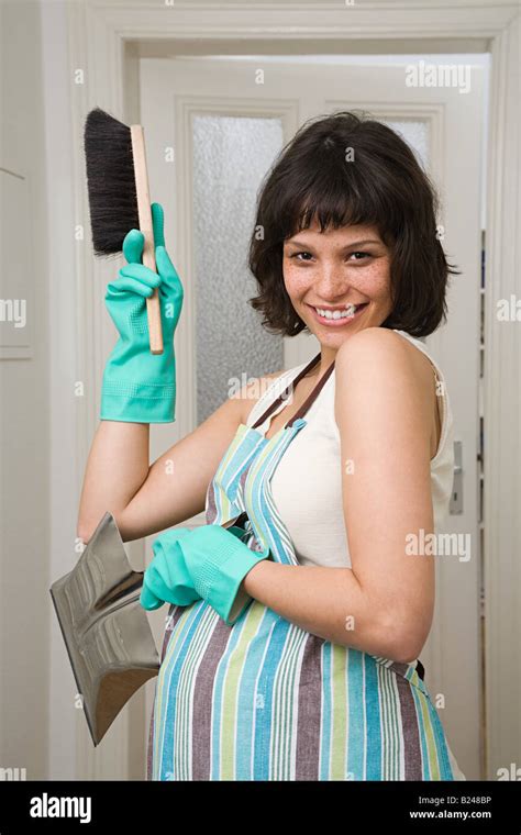 Pregnant Woman With Dustpan And Brush Stock Photo Alamy