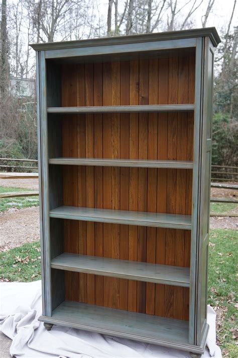 Custom Bookcase With Blue Hand Painted Finish And Stained Plank Back