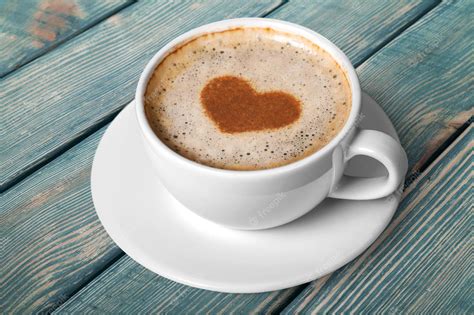 Premium Photo Coffee With Heart Shaped Foam On Wooden Background