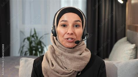muslim arabian islamic woman girl lady wearing hijab in headset having online video call