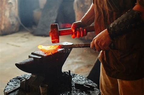Manual Work Of A Blacksmith In A Blacksmith Shop Hammer Blows On The