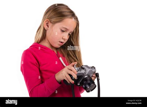 Young Girl Looking Down On A Vintage Slr Camera Isolated On A White