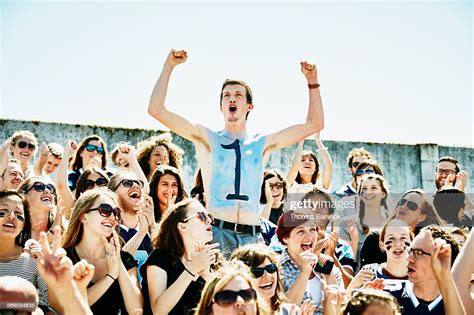Painted Football Fan Cheering In Crowd In Stadium High Res Stock Photo