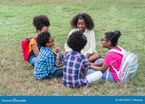Happy Group Of African American Children Sitting Together In Circle On
