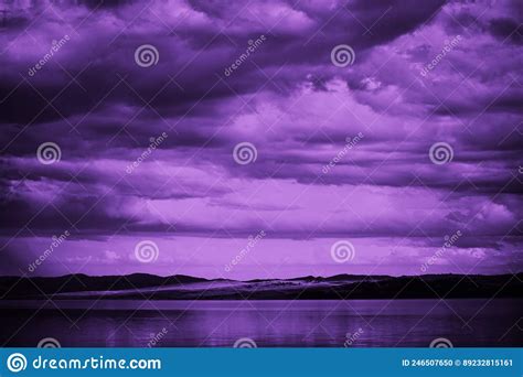Purple Sunset Sky With Clouds Over The Sea Dramatic Mountains On The