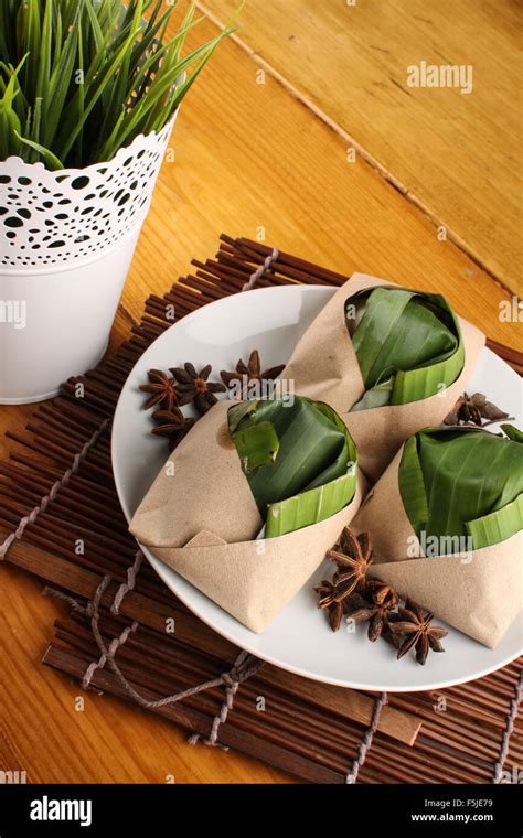 Traditional Fresh Malaysian Nasi Lemak Packed With Banana Leaf In Wood