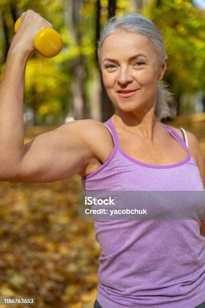 Smiling Athletic Tranquil Woman Flexing Her Arm Stock Photo Download