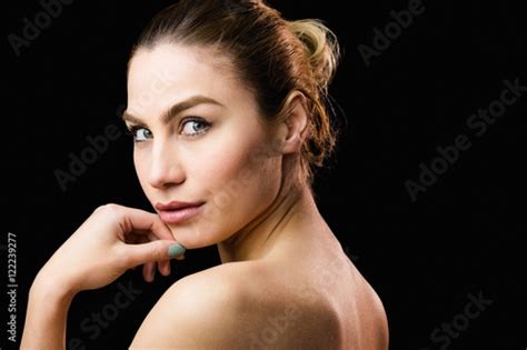 Portrait Of Beautiful Woman Posing Against Black Background Stock