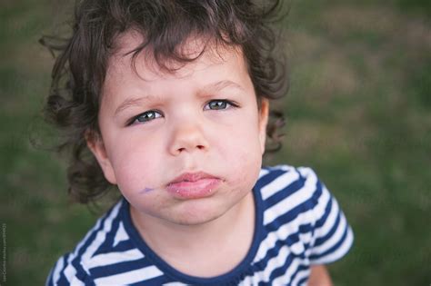 Portrait Of A Child With A Messy Dirty Face Looking At Camera By