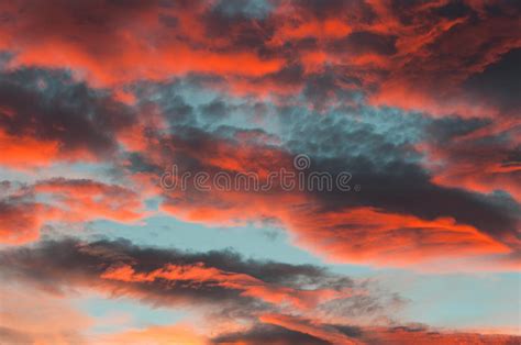 Fantastic Red Clouds In Blue Sky During Sunset Stock Photo