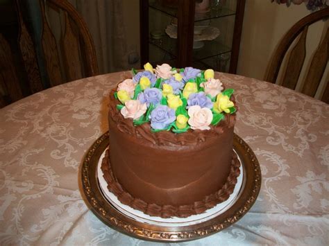 Decorating a cake can be as complex or as easy as you wish. Three Layer Nuttella Fudge Cake With Marshmallow Fondant Flowers - CakeCentral.com
