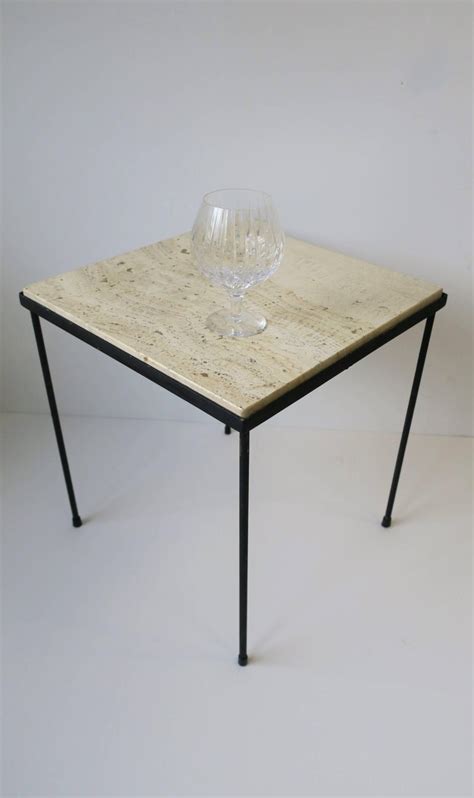 Travertine marble is often visibly porous, giving it a more natural, textured look. Italian Square Travertine Marble and Black Metal Side or ...