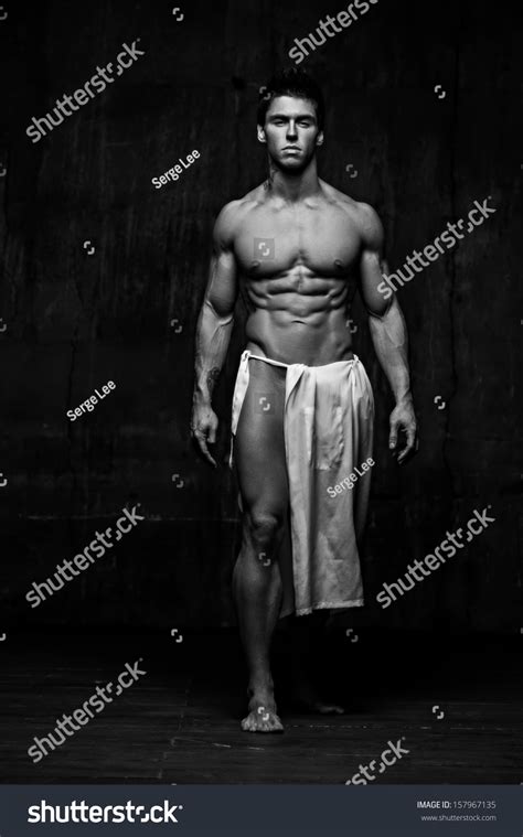 Naked Male Model Against Black Background Stock Photo