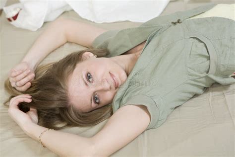 Serious Woman With Long Hair Lying On Bed Stock Photo Image Of