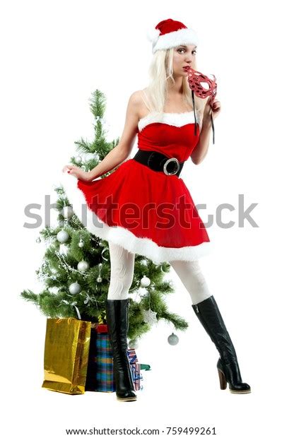 Beautiful Sexy Blonde Girl In A Christmas Costume At A Christmas Tree On A White Background Isolated