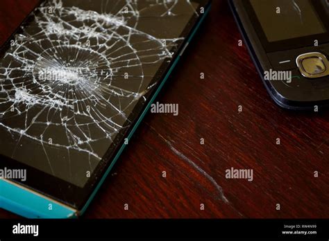 Mobile Phone With Broken Screen Cracked Smartphone Screen Stock Photo