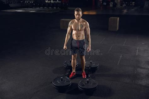 Young Healthy Male Athlete Doing Exercises In The Gym Stock Photo