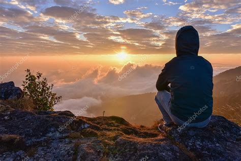 Man Sitting On A Mountain For Watching Sunrise Views Stock Photo