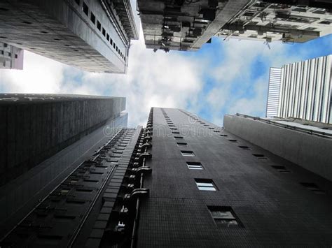 Upward View Of Tall Skyscrapers Against A Blue Sky And Clouds Stock