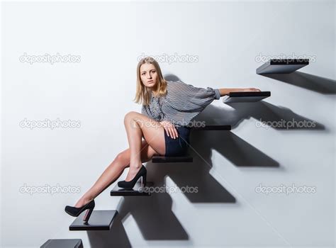 Sexy Woman Lying On Stairs Over Grey Bakground Stock Photo By Julenochek