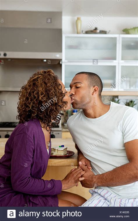 Couple Kissing In Kitchen Stock Photos And Couple Kissing In Kitchen