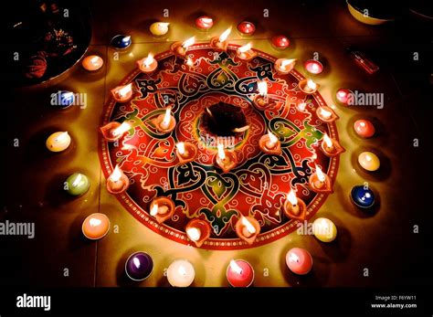 Diwali Rangoli With Colorful Burning Candles And Diyas During Hindu