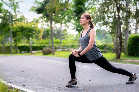 Young Asian Woman Runner Doing Stretch Exercise Stretching Legs Stock