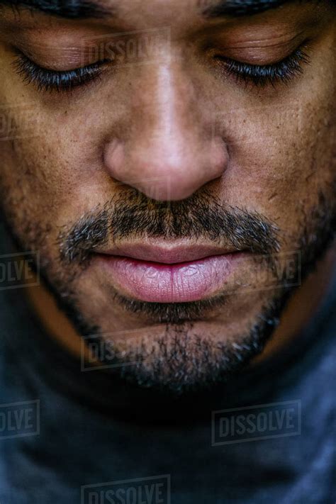 Close Up Of Face Mixed Race Man Looking Down Stock Photo Dissolve