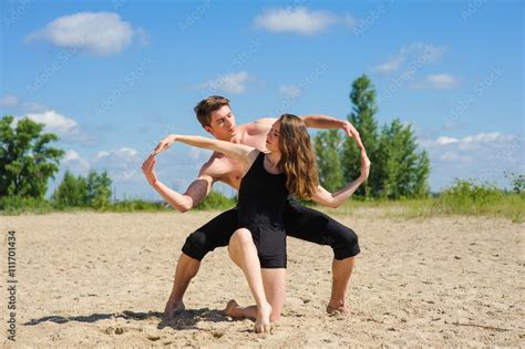 Contemporary Dance Man And Woman In Passionate Dance Pose On Beach