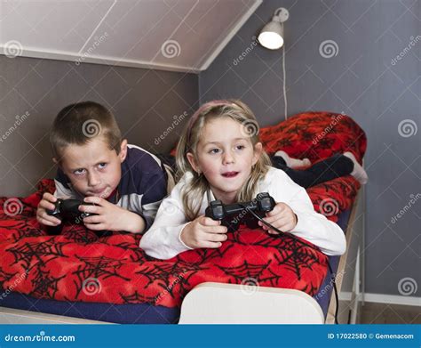 Siblings Playing Video Games Stock Photo Image Of Children Handheld