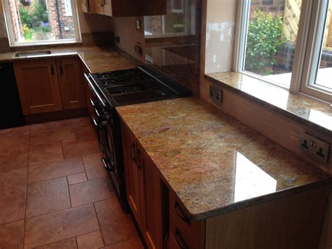 Slate grey kitchen units with white and grey marble worktops. Quality Granite & Quartz Kitchen Worktops - Wirral