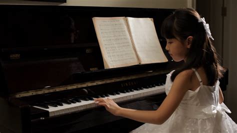 Ms Rear View Of Girl Wearing White Dress Playing Piano China Stock