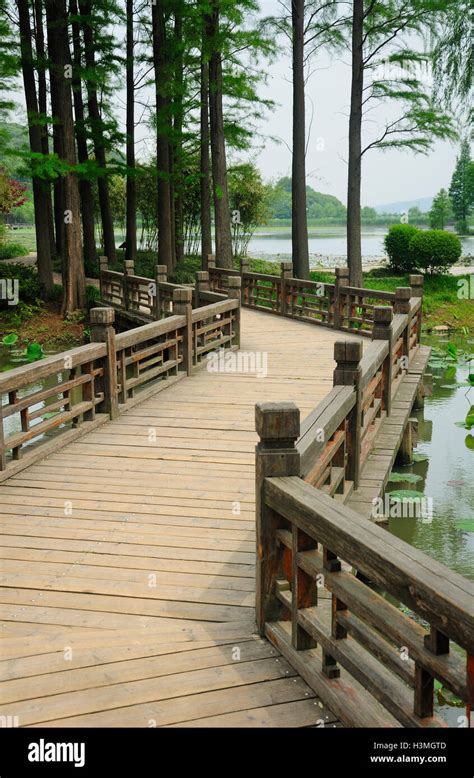 A Wooden Zig Zag Bridge Over Water At The Lake Tai Tai Hu Scenic Area